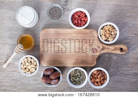 Grain free oat free paleo granola ingredients: mixed nuts seeds goji berries chia honey and coconut oil selective focus