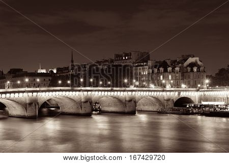 River Seine and Pont Neuf at night in Paris, France.