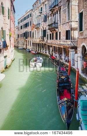 Boat And Gondola With People In Narrow Canal