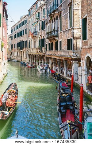 Boats And Gondolas With Tourists In Narrow Canal