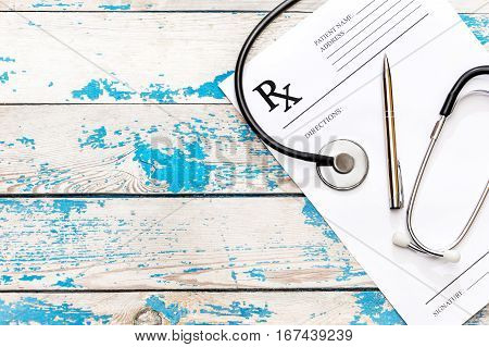 Prescription form with stethoscope and pen. Medical concept. Top view.