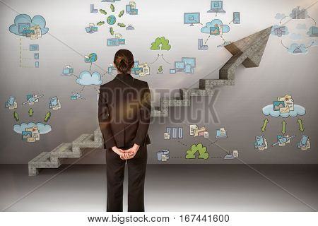 Businesswoman standing with hands behind back against digital composite image of gray steps moving up