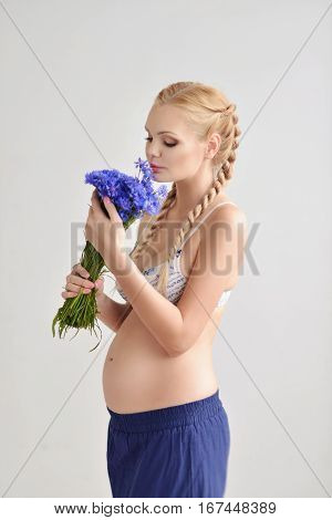 Portrait young pregnant woman with a flower