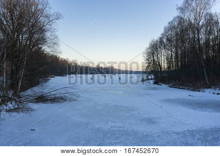 People on a frozen Lake
Kuhsee in Winter. 
Augsburg - Germany