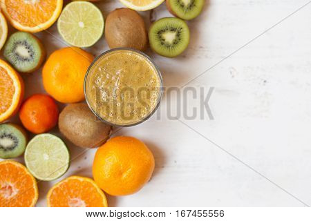 Smothie rich in vitamin C made with oranges, lemons, limes, clementines, kiwis, top view, selective focus