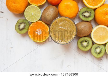 Smothie rich in vitamin C made with oranges, lemons, limes, clementines, kiwis, top view, selective focus