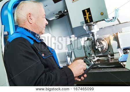 industrial worker working with cnc milling machine