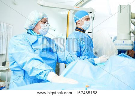 Interventional cardiology. Male surgeon doctor at operation