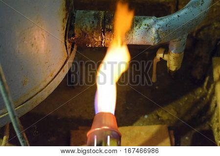 Heating A Steel Pipe With A Blowtorch. The Flame Of A Blowtorch
