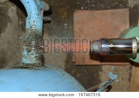 Heating A Steel Pipe With A Blowtorch. The Flame Of A Blowtorch