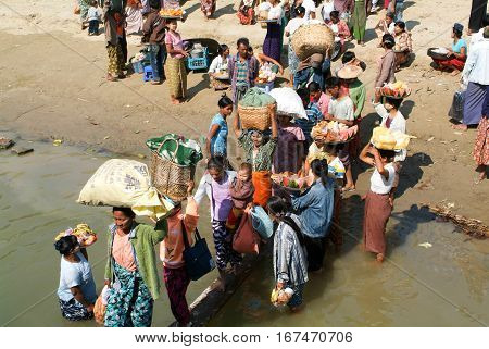 River Ayeyarwady Myanmar - 20 January 2010: People selling food on the Ayeyarwady river bank Myanmar