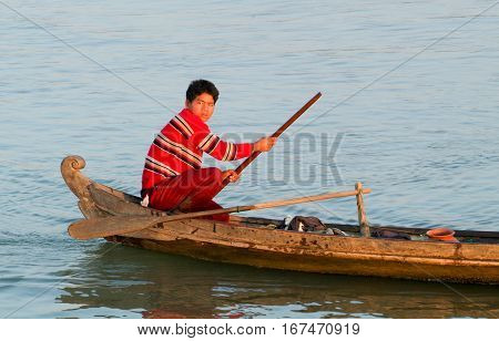 River Ayeyarwady Myanmar - 20 January 2010: fisherman rowing on his canoe at the river Ayeyarwady on Myanmar