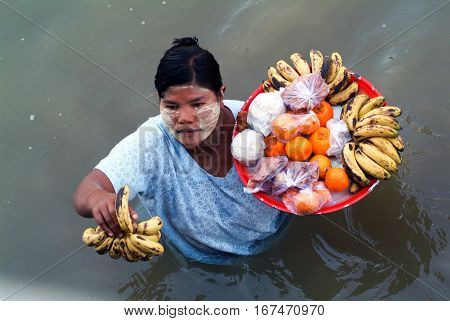 River Ayeyarwady Myanmar - 20 January 2010: People selling food on the Ayeyarwady river bank Myanmar