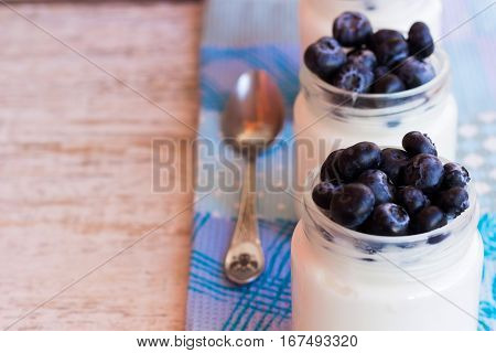 Homemade yogurt with blueberries in a glass jar