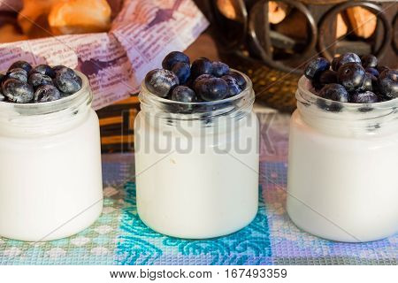 Homemade yogurt with blueberries in a glass jar