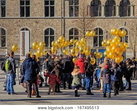 Zurich, Switzerland - 29 January, 2017: a group of people with balloons bearing the symbolic of the C3 Church on the square at the entrance to the Swiss National Museum.