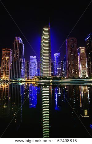 View on the Jumeirah Lakes Towers skyscrapers at night. Dubai UAE.