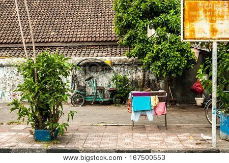 Scene behind the city walls with laundry and vehicle in Yogyakarta, Indonesia
