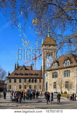Zurich Switzerland - 29 January 2017: a group of people launching balloons bearing the symbolic of the C3 Church on the square at the entrance to the Swiss National Museum.