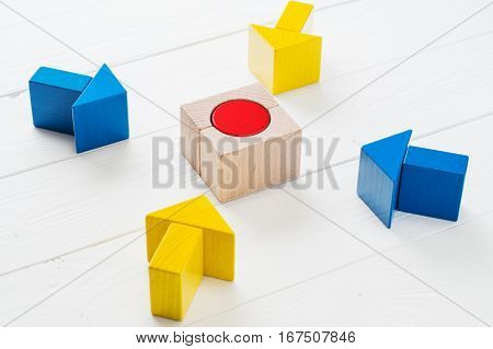 Four wooden arrows converge towards the center target. Arrows pointing to the object. The concept of the goal the implementation of the planned success. Symbol of goal and objective.