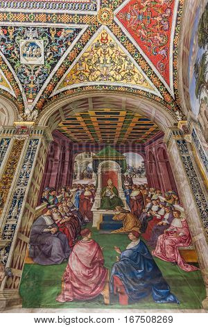 SIENA ITALY - MARCH 14 2014: Detail of fresco in The Piccolomini library inside the Siena cathedral. The library is housing precious illuminated choir books and frescoes painted by Pinturicchio.