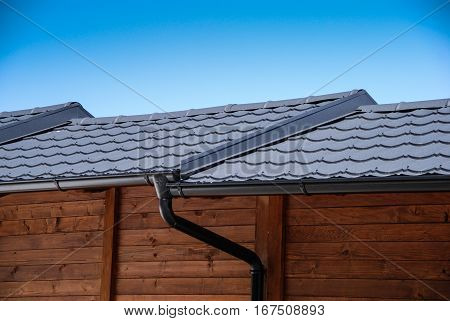 Wooden buildings with black steel rain gutters