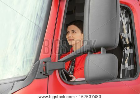Young woman driving big modern truck