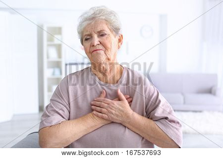 Elderly woman having heart attack at home