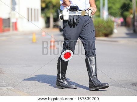Black Boots And Traffic Pallet Of A Traffic Policeman In The Cit