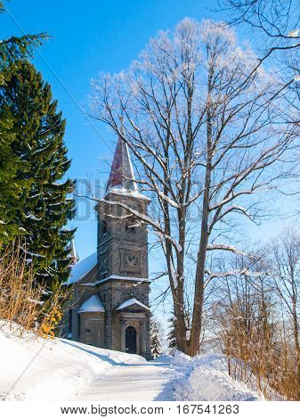 Rural church in rococo architectural style in winter time, Horni Tanvald, Northern Bohemia, Czech Republic, Europe.