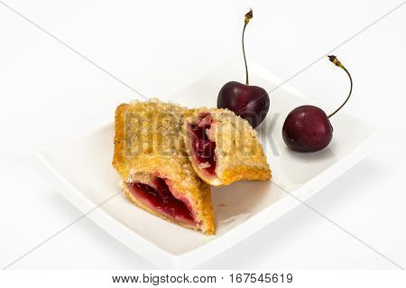 Puff pastry with fresh cherries on a white background