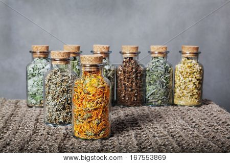 Different kinds of herbs. Dried, calendula, foreground Linen cloth
