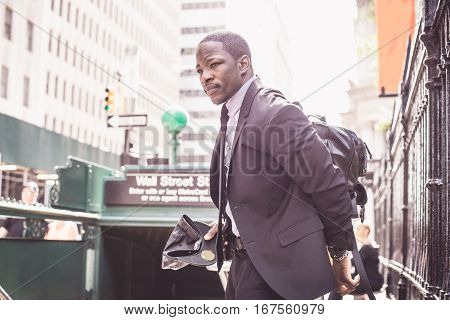 Businessman in full suit at Wall Street subway metro station