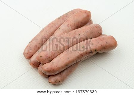 A stack of six raw chipolata sausages ready for cooking