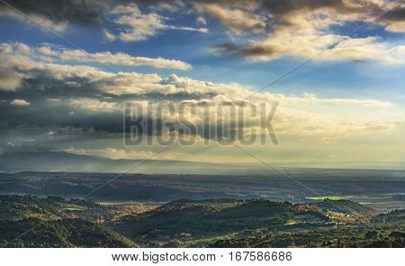 Maremma sunset panorama. Countryside hills and sea on horizon. Val di Cecina Livorno coast Tuscany Italy Europe
