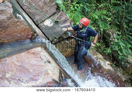 Beaufort,Sabah,Malaysia-Jan 28,2017: A adventurer canyoneer get ready to abseil down a waterfall in Beaufort,Sabah,Borneo.Waterfall Abseiling activity adventure getting famous in Sabah,Malaysia.