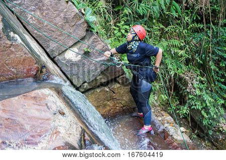 Beaufort,Sabah,Malaysia-Jan 28,2017: A adventurer canyoneer get ready to abseil down a waterfall in Beaufort,Sabah,Borneo.Waterfall Abseiling activity adventure getting famous in Sabah,Malaysia.