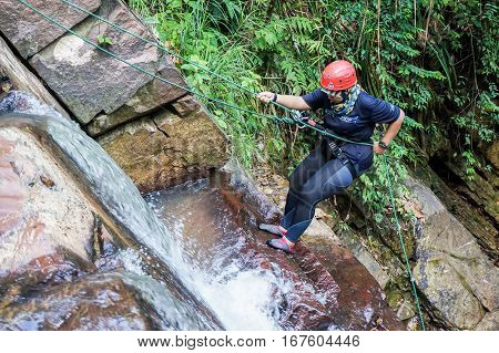 Beaufort,Sabah,Malaysia-Jan 28,2017: A adventurer canyoneer get ready to abseil down a waterfall in Beaufort,Sabah,Borneo.Waterfall Abseiling activity adventure getting famous in Sabah,Malaysia.