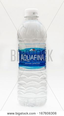New York, January 23, 2017: A bottle of Aquafina water stands isolated against white background.