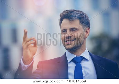 Close up of cheerful businessman gesturing outdoors