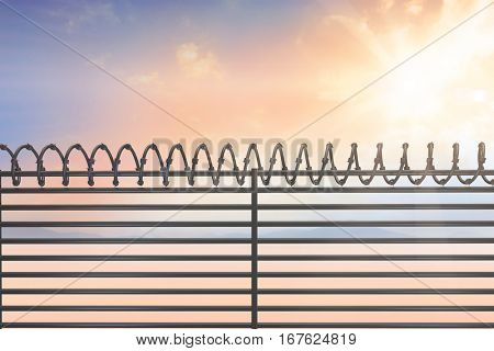 Digitallly generated image of barbed wire on fence against desert landscape