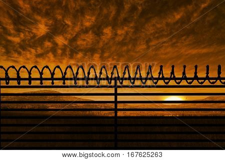 Digitallly generated image of barbed wire on fence against beautiful african scene 3d