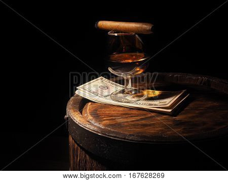 Cognac ,cigar And Dollars On Old Oak Barrel