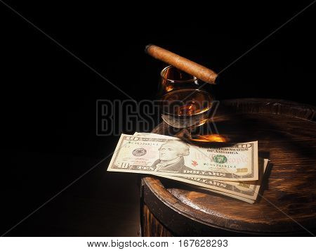 Cognac ,cigar And Dollars On Old Oak Barrel