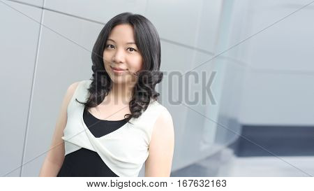 Young asian business woman smile face on modern buliding background