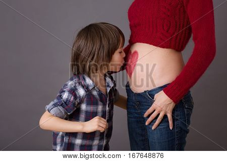 Beautiful Preschool Child, Hugging His Pregnant Mom