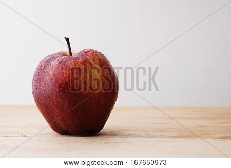 Apple on the table with a water to indicate fresh