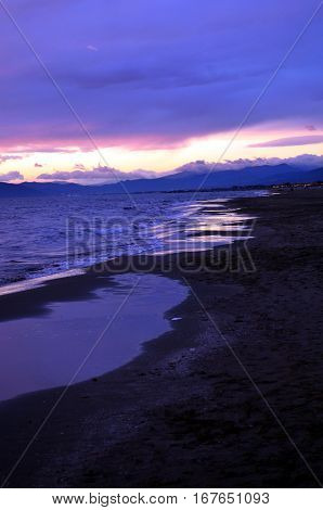 Sunset over a sea during tide.
Sea waves during a colorful sunset over a beautiful and romantic beach