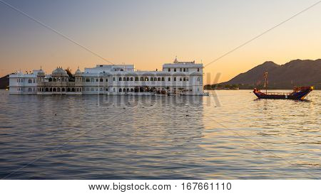 The Famous White Palace Floating On Lake Pichola At Sunset. Udaipur, Travel Destination And Tourist