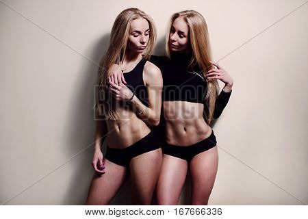 Two young beautiful woman twins blonde. sexy twins couple.girls
